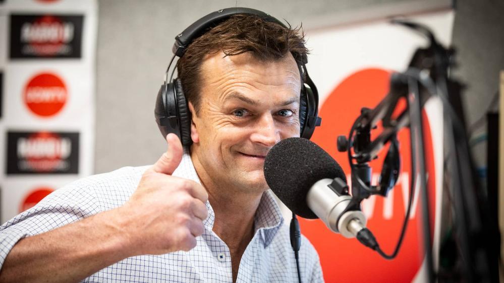 Adam Gilchrist gives a thumbs up as he broadcasts from a UOW studio. Photo: Paul Jones