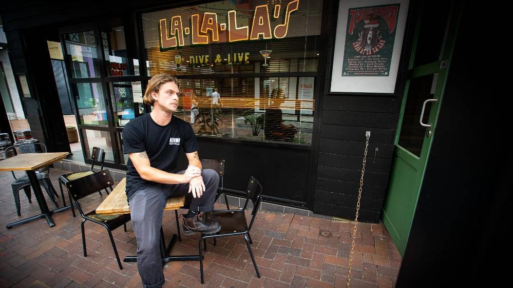 A man sits in front of La La La's bar in Wollongong. Photo: Paul Jones