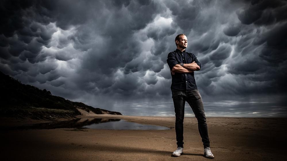 Hampus Eriksson, pictured standing at the beach against a cloudy sky. Photo: Paul Jones