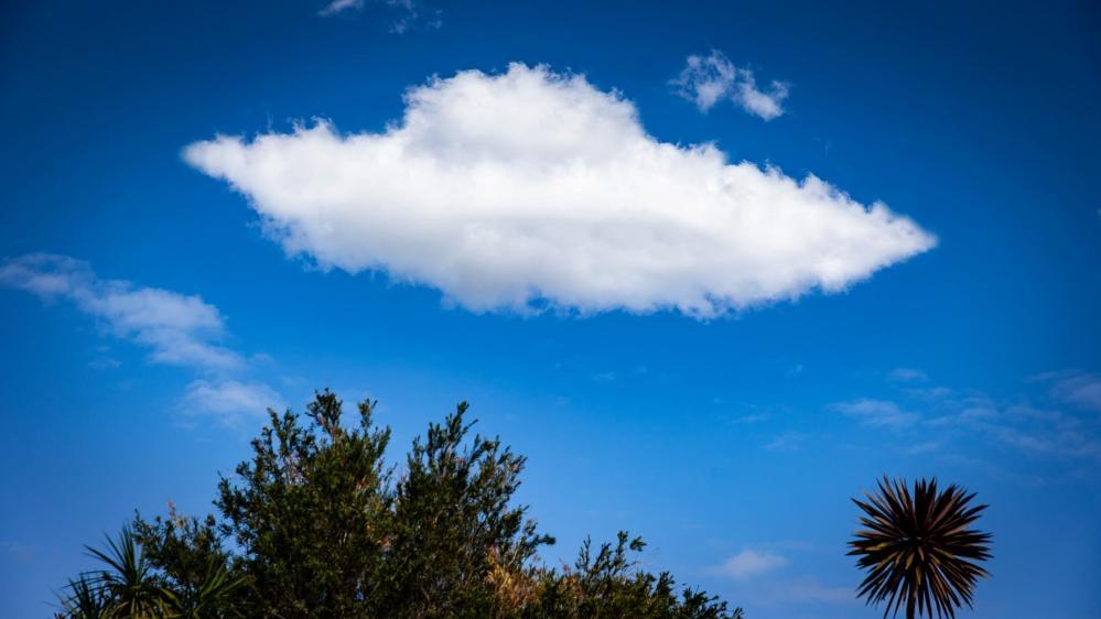 A cloud that looks like a UFO is pictured in a blue sky. Photo: Paul Jones