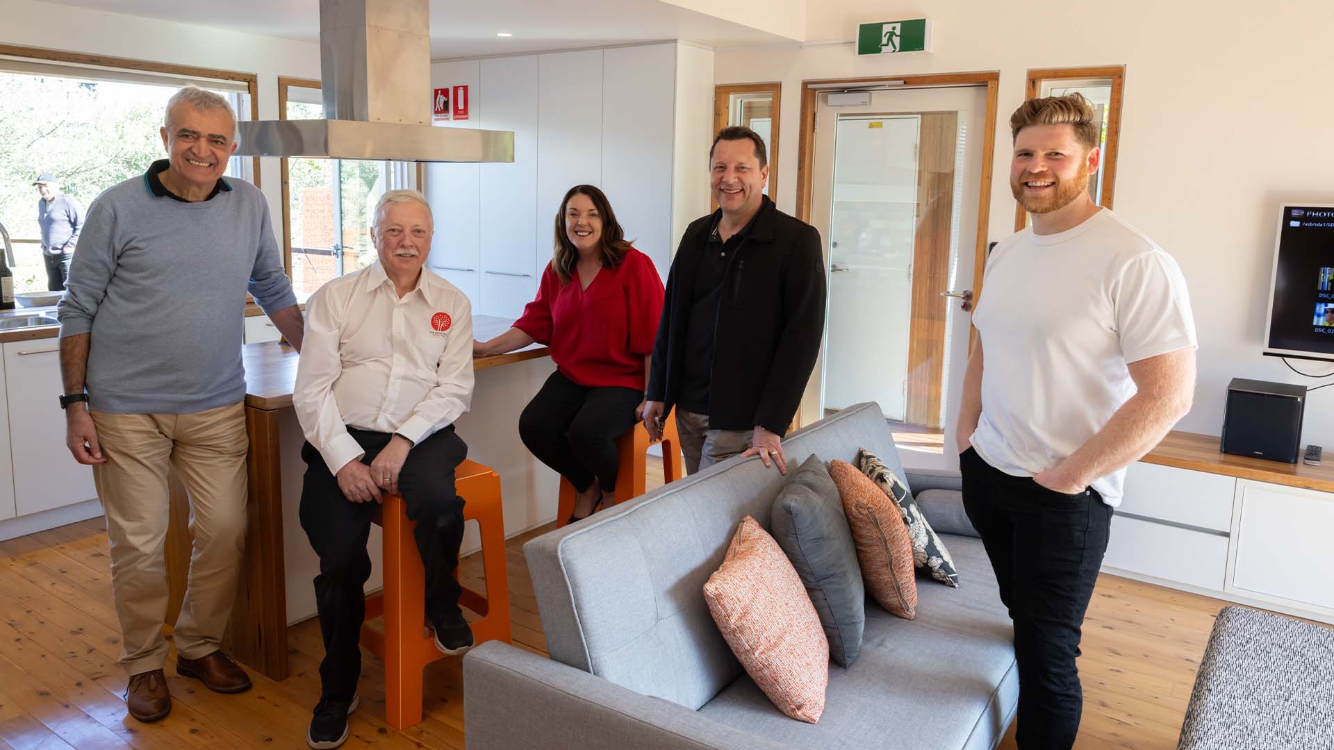 Academics and politicians pose inside the Illawarra Flame House