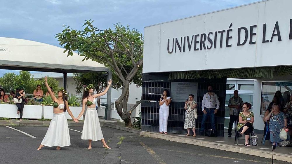Two women perform a traditional Tahitian dance for students arriving at the University of French Polynesia.