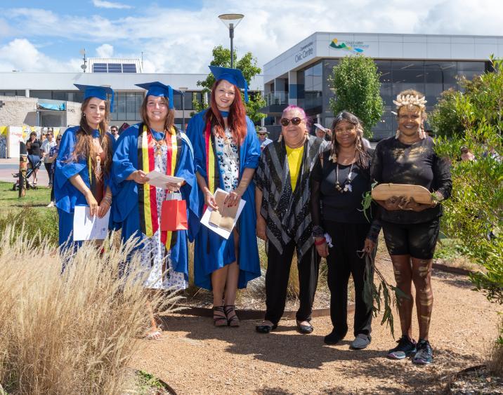 Three graduates with Indigenous Elders from Bega Community