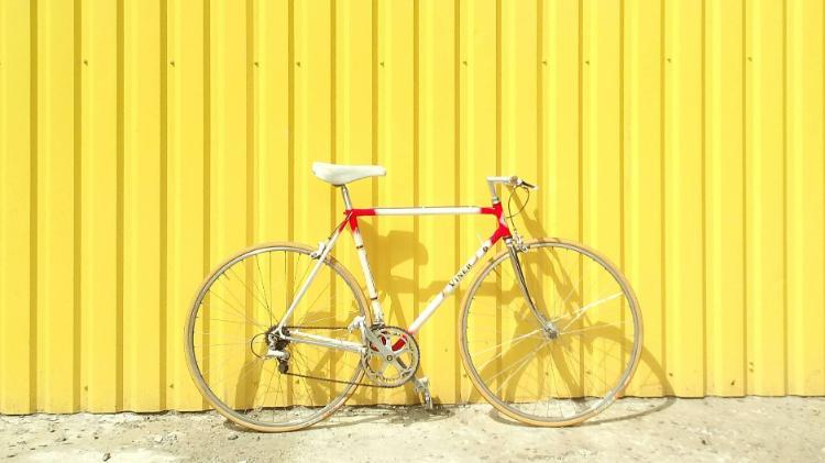 image of bicycle against yellow wall