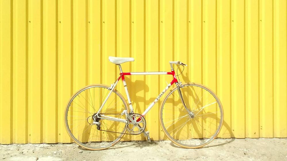 image of bicycle against yellow wall