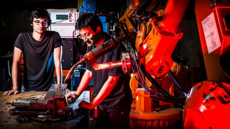 Nathan Larkin and Dr Zengxi Pan use robotic welding machine
