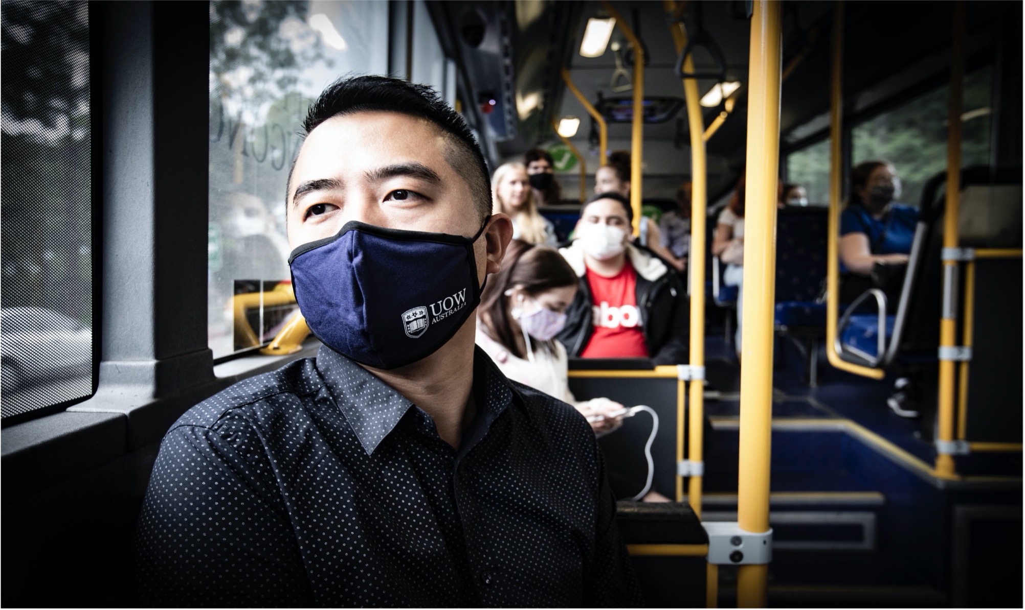 Man sitting on bus with face mask on