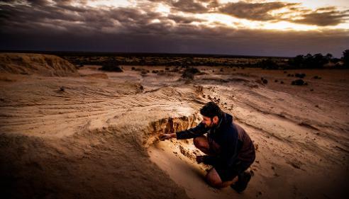 UOW CABAH researcher Nathan Jankowski examines soil on Lake Mungo