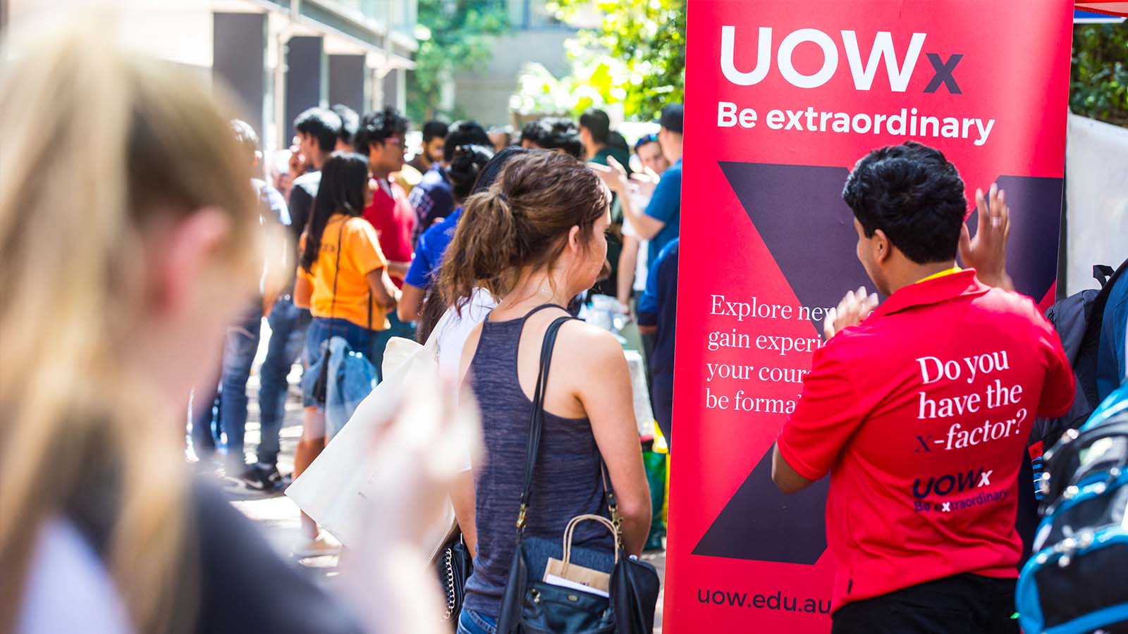 Student enquiring at UOWx stand