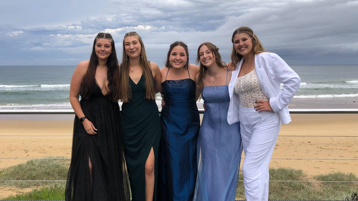 five students dressed up at high school graduation