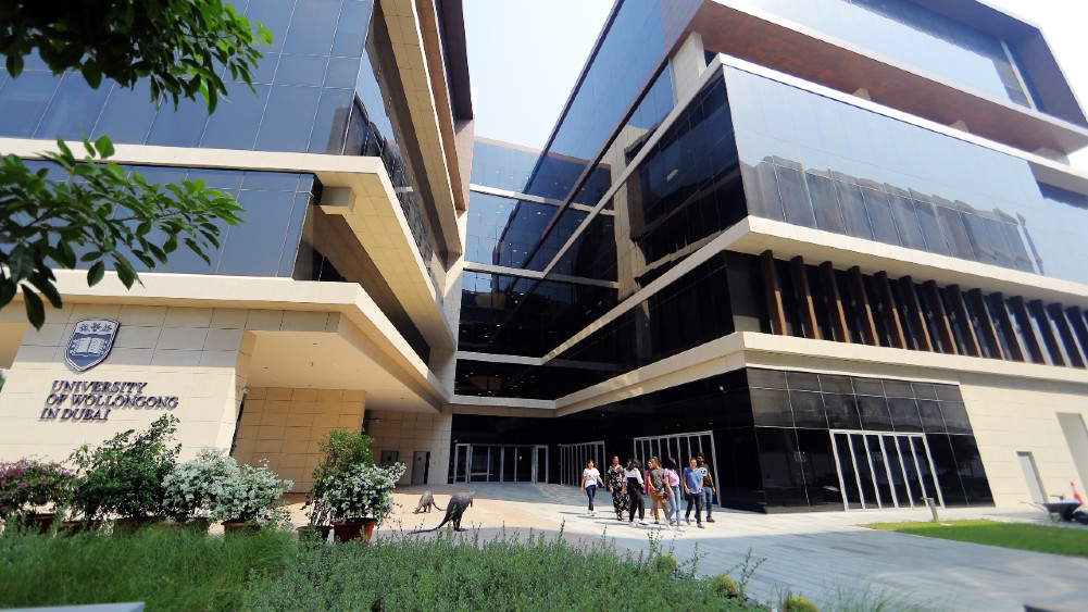 Students walking outside a building at UOW Dubai