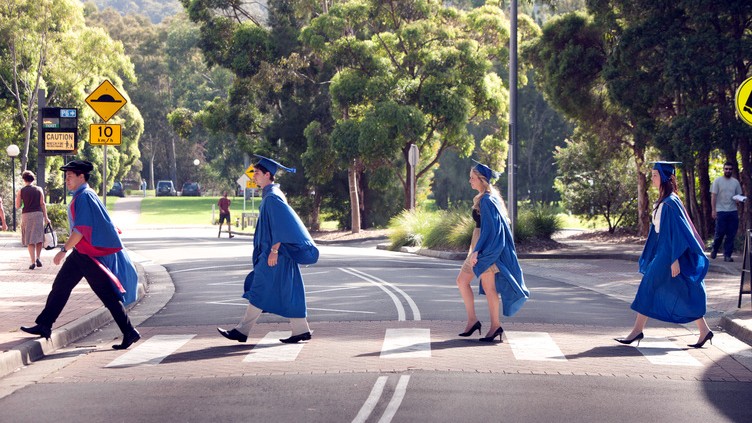 UOW graduates crossing road near UOW campus