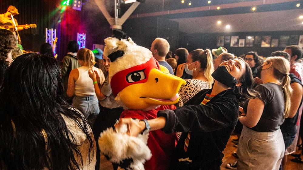 Students dancing with UOW mascot Baxter the Duck at the UniBar during OWeek