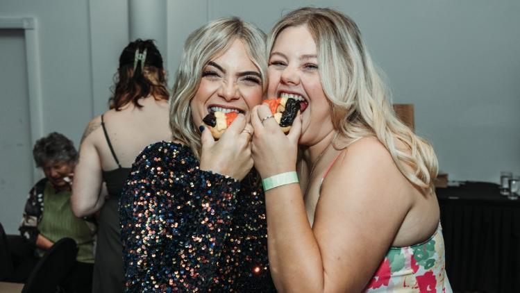 Students eating donuts at the Indigenous Awards 2022