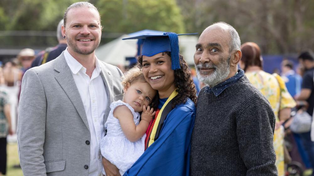Janaya Pender graduation photo with fiance, daughter and father