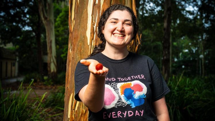 Stephanie Beaupark holding a fruit in her hand