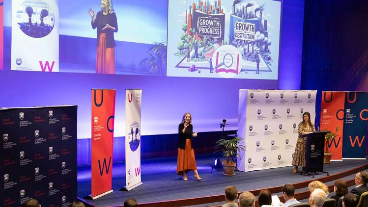 a student presents her submission on stage