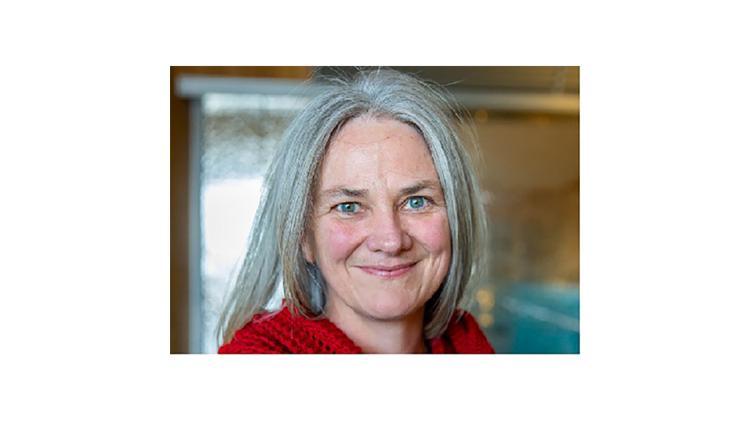 Associate Professor Jacqueline Broad smiling wearing a red top.