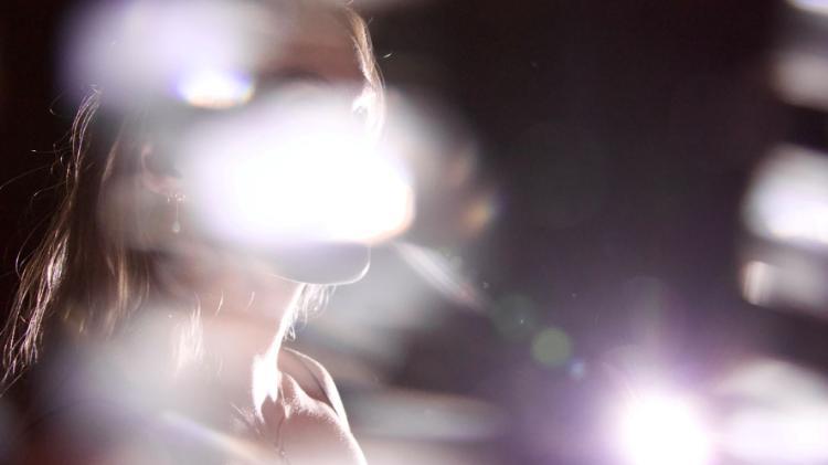 Face of female blocked by a light reflection