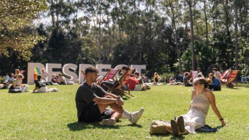 RESPECT letters on lawn with students socialising in foreground