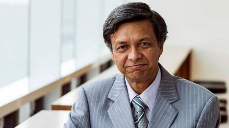 Professor Pradeep Kumar Ray wearing a grey suit and tie.
