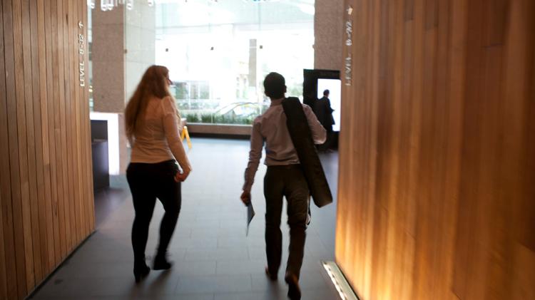 Students walking through the corridor of Sydney Business School