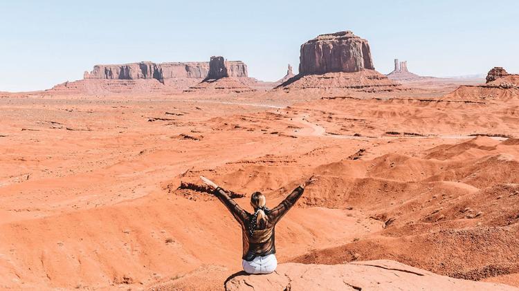 Student sitting on a rock in the USA desert