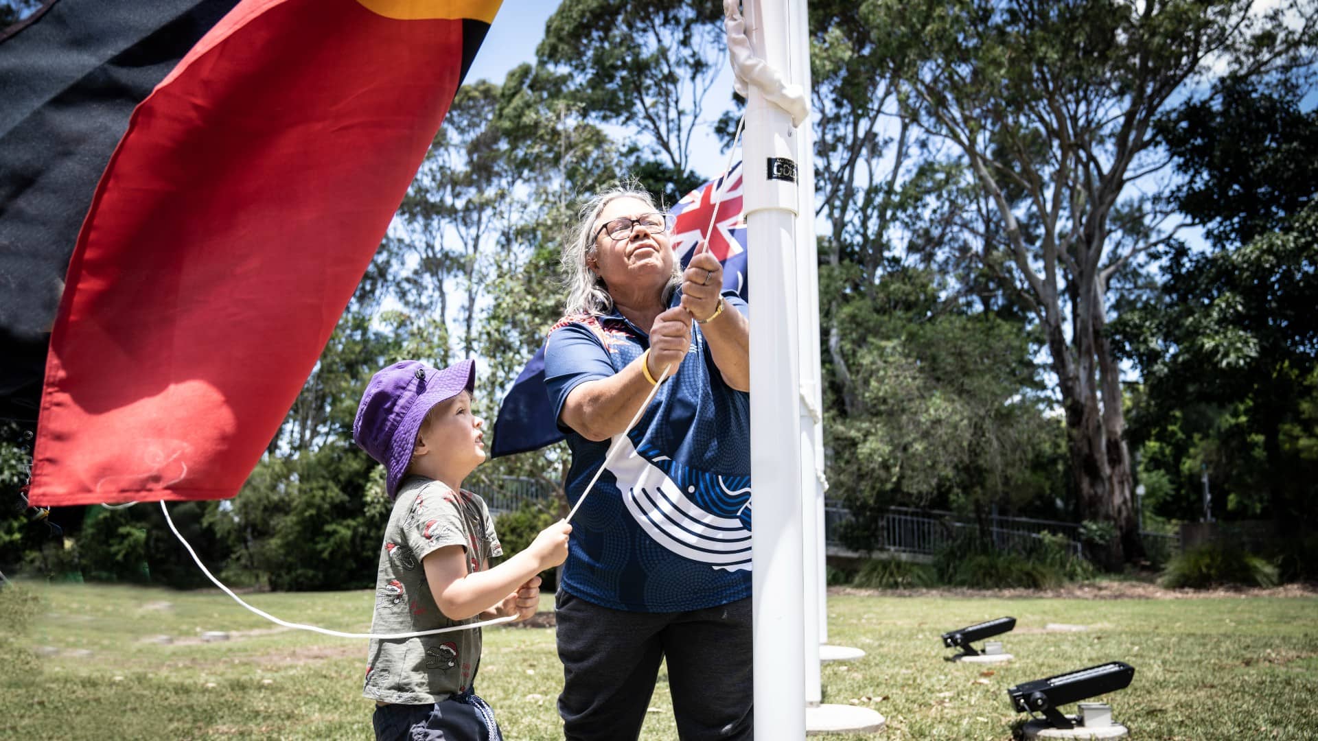 Aunty May with Kids Uni student Kayden Little, who is helping to raise the Aboriginal Flag at Wollongong Campus. Photo: Paul Jones