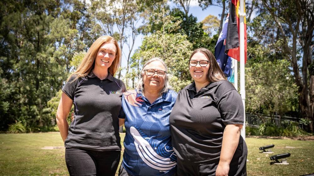 Kids Uni Director Kellie Grose, Aunty May, and Jordan Storm at the Aboriginal Flag raising at Wollongong Campus. Photo: Paul Jones