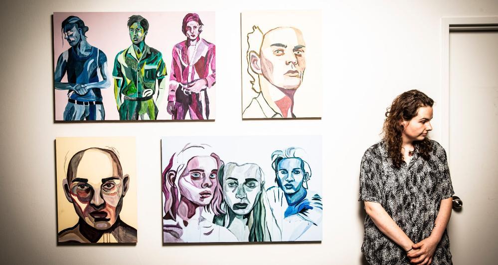 Creative arts graduate Ali Orlowski in front of her artwork in the show Zenith. Photo: Paul Jones