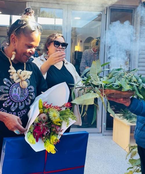 Two people take part in a Smoking Ceremony outside UOW Bega Valley Campus. Photo: Supplied