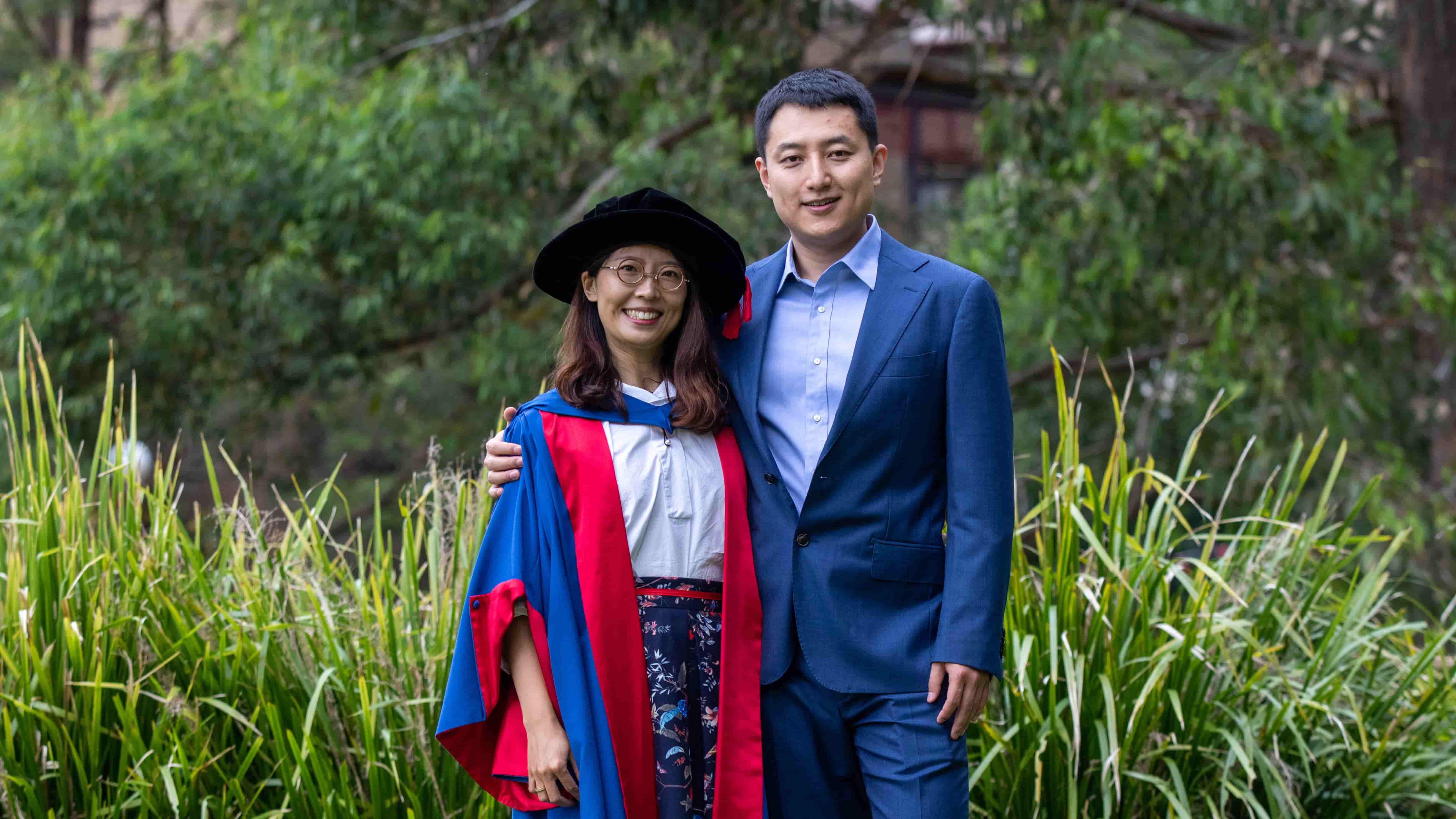 Jin Zhao and Helen Qiu stand closely after celebrating their engagement at graduation. Photo: Andy Zakeli
