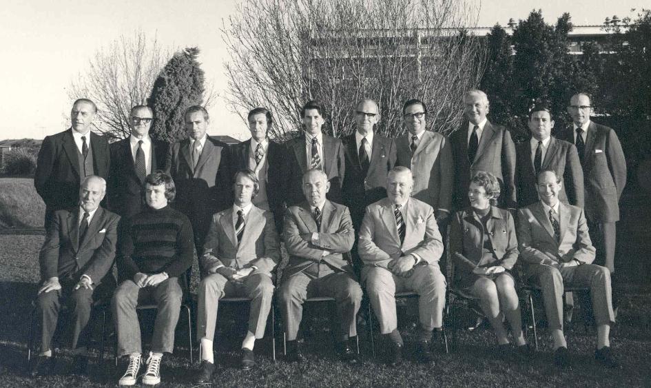 A black and white image of two rows of the representatives of UOW's Interim College Council, taken in 1974. There are ten men standing in the back and seven sitting in the front.