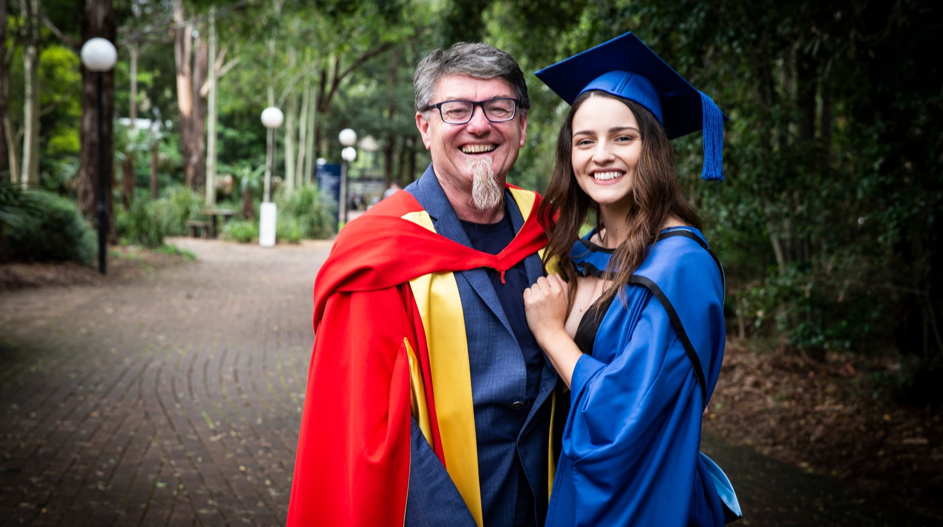 Biomedical engineering graduate Eileen Wallace with her father Professor Gordon Wallace in her graduation gown at UOW's Wollongong campus. Photo: Paul Jones
