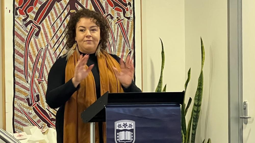 UOW Bega Valley Indigenous Student Success Advisor Emma Stewart stands at a lectern and speaks to the crowd at the Djiringanj Learning Resource Launch. Photo: Supplied