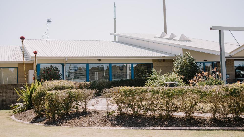 An exterior image of UOW Eurobodalla, with bushes in the foreground. Photo: Michael Gray