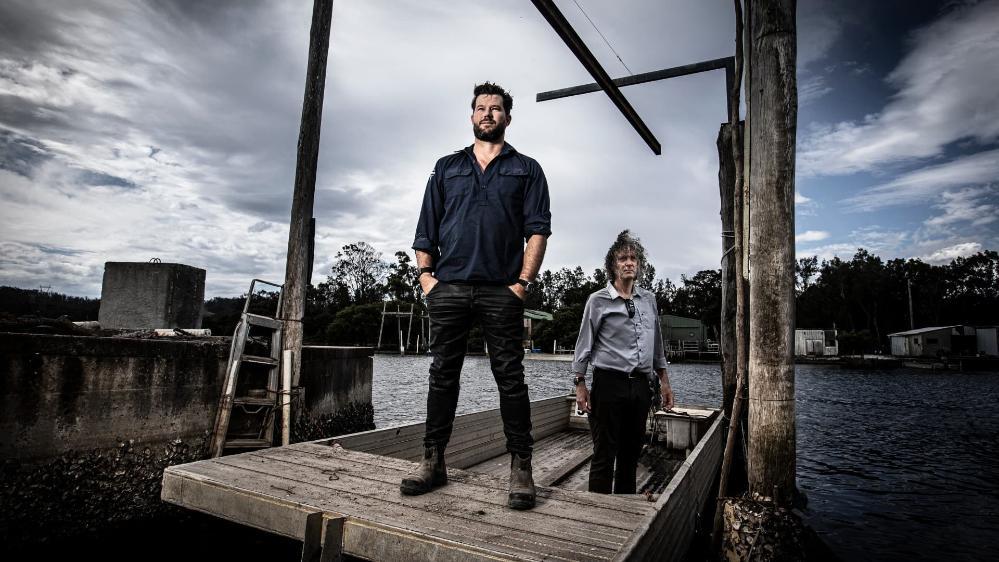 Batemans Bay oyster family stands alongside UOW researcher Hugh Forehead on the Clyde River. Photo: Paul Jones