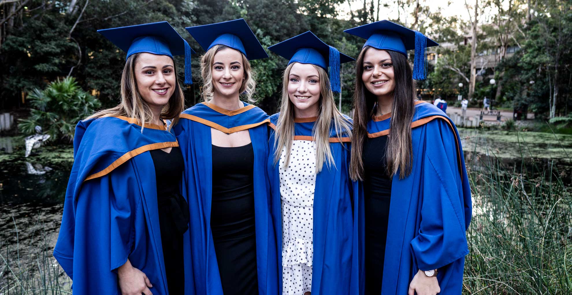 Four female students celebrate their graduations from UOW. Photo: Paul Jones