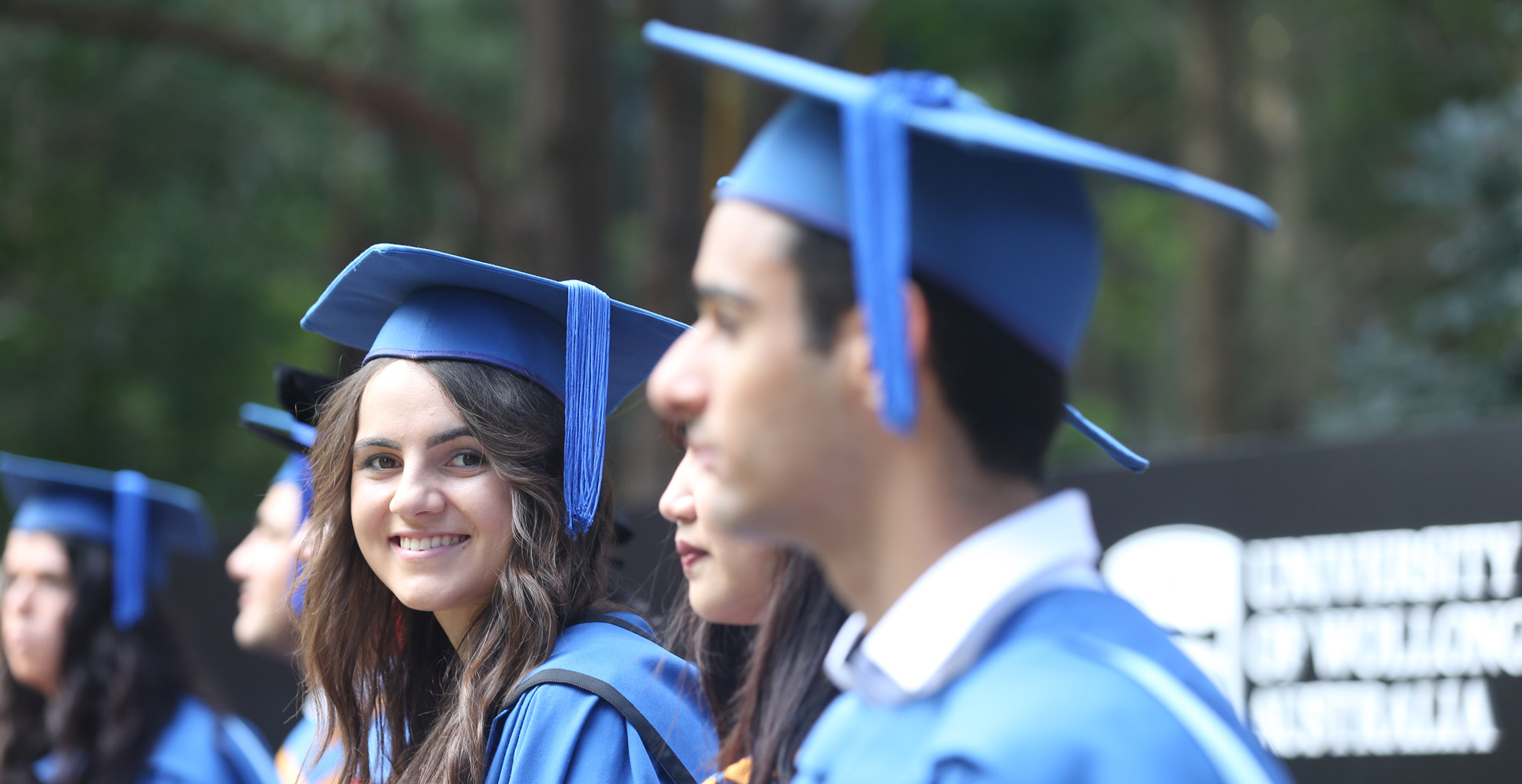 A graduate smiles at the camera during the graduation ceremonies. Photo: Paul Jones