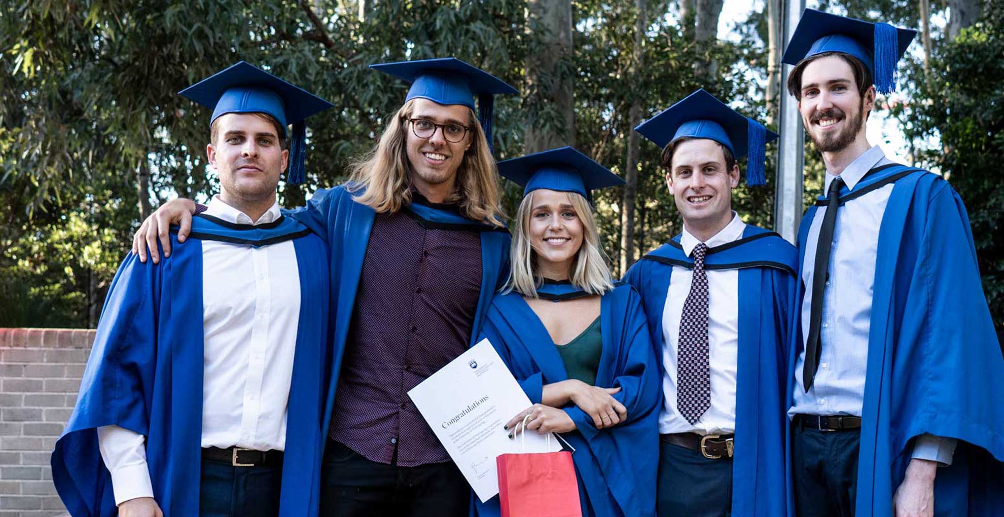 A group of students celebrate their graduations. Photo: Paul Jones