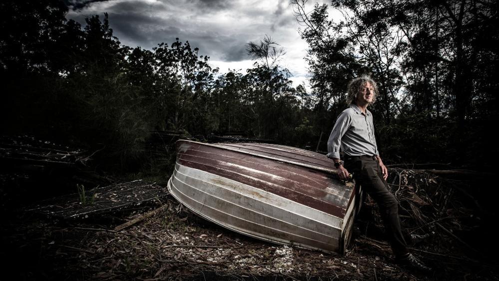 UOW researcher Hugh Forehead, standing against a boat on the Clyde River near Batemans Bay. Photo: Paul Jones