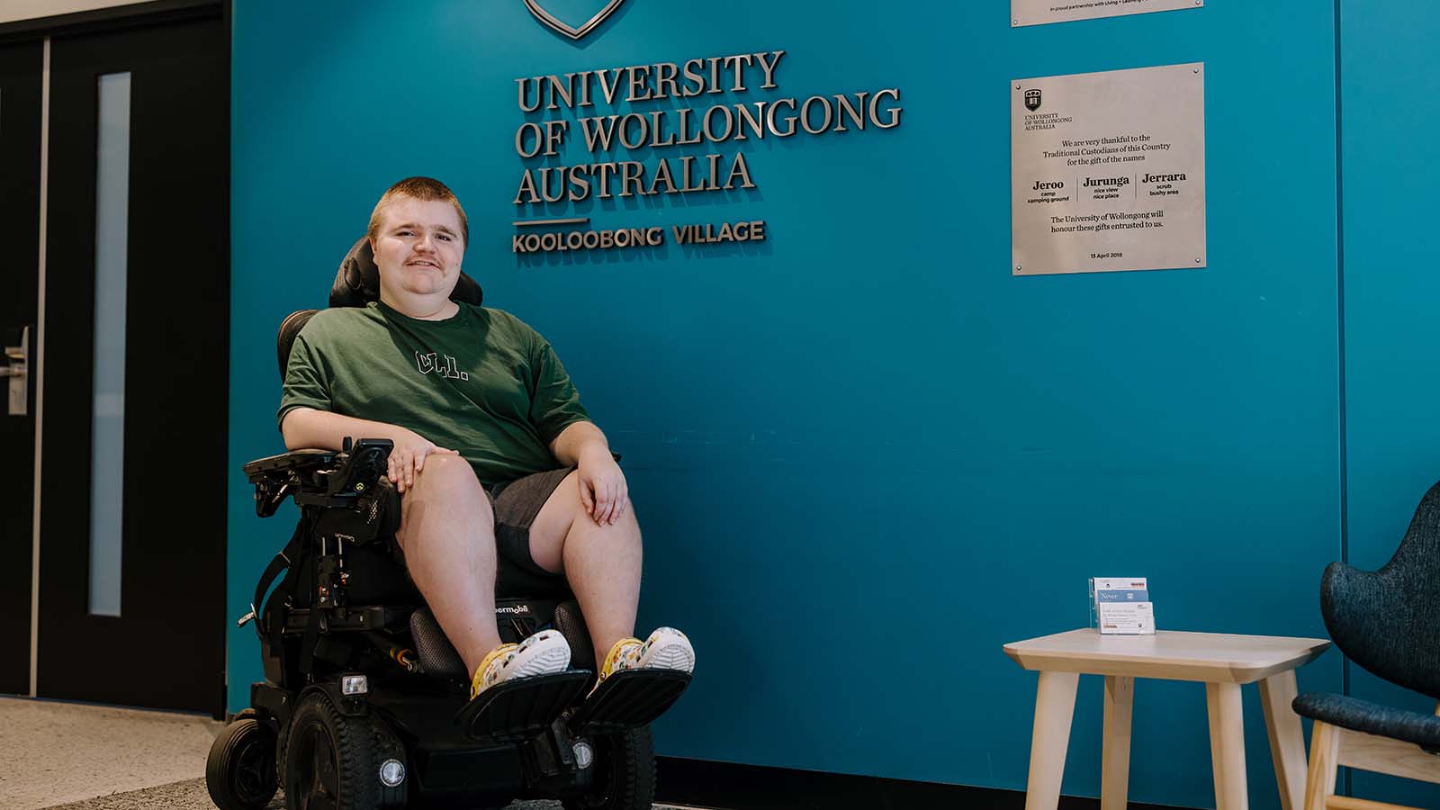 UOW IT graduate in a wheelchair poses in UOW Kooloobong residence