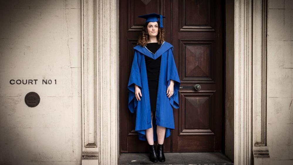 UOW graduate Jamie Coleman, pictured outside a courthouse in Wollongong, wearing a black dress. Photo: Paul Jones