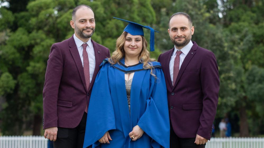Lord Thabet, centre in her graduation gown and cap, with her brother Fadi to the left and her brother Majd to the right. Photo: Andy Zakeli