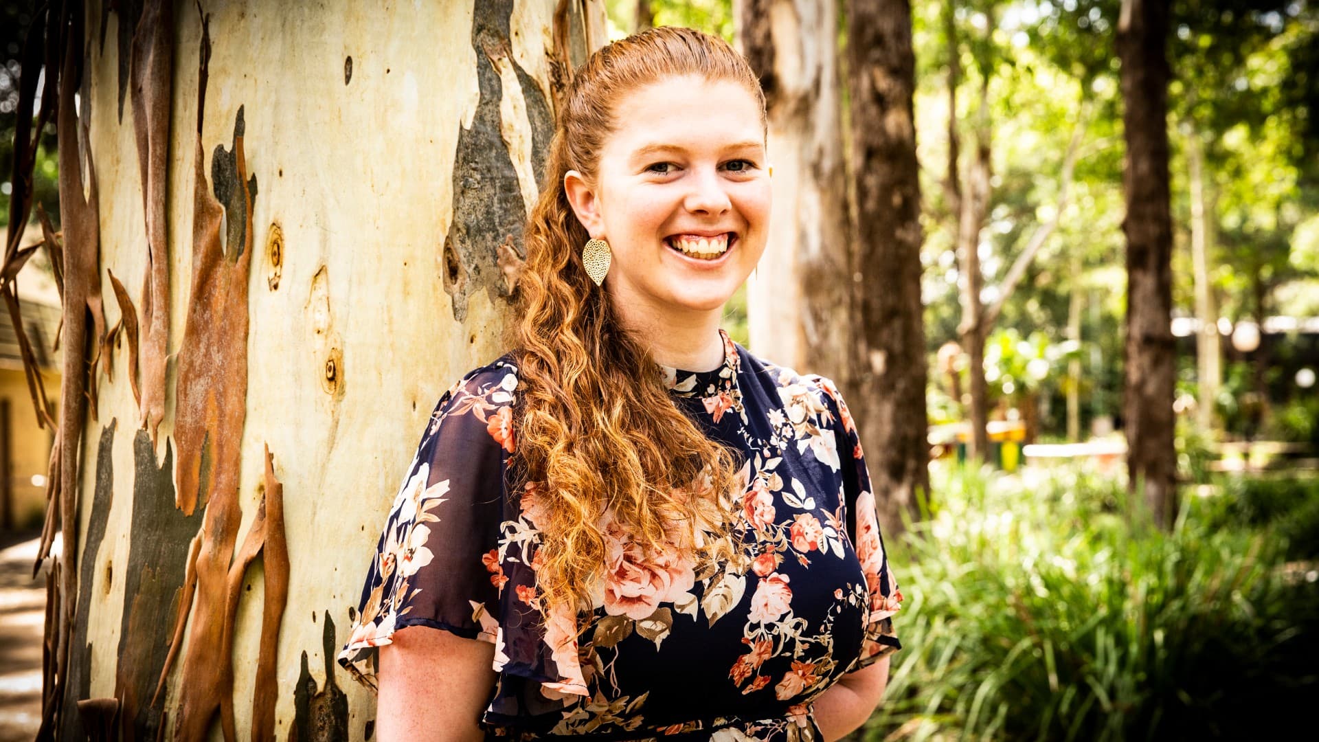 UOW graduate Meg Cummins, pictured standing against a tree at UOW's Wollongong campus. Photo: Paul Jones