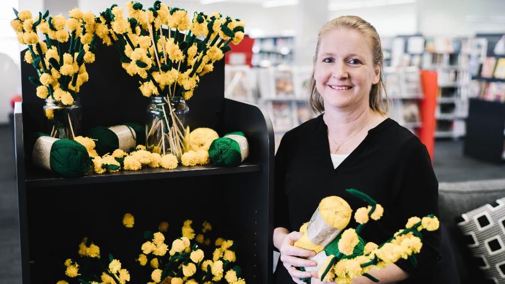 Nicola Bath from UOW Batemans Bay with the knitted wattle flowers that will be on display. Photo: Sunbird Photography