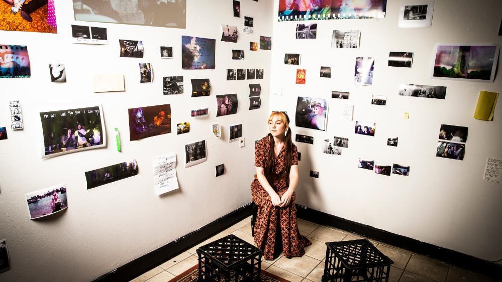 Creative arts graduate Nova Tucker in front of her artwork in the show Zenith. Photo: Paul Jones