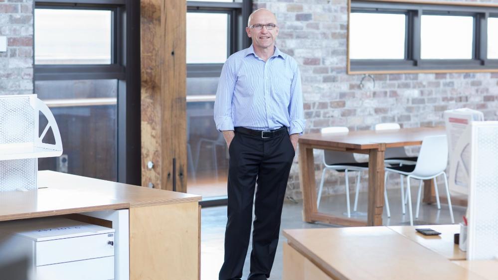 Professor Paul Cooper stands in the kitchen of the Sustainable Buildings Research Institute.