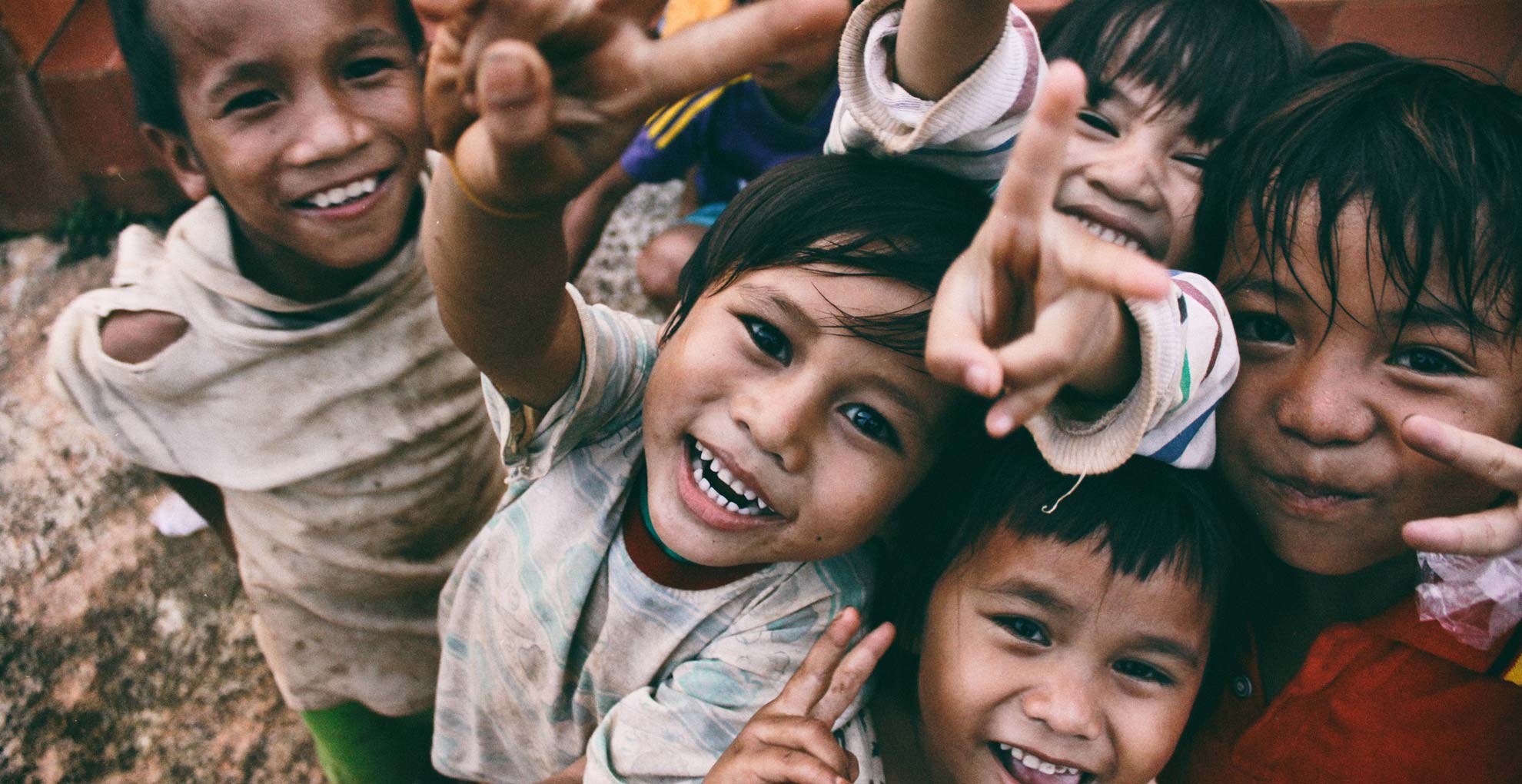 A group of children smile for the camera in Vietnam. Photo: Larm Rmah/Unsplash