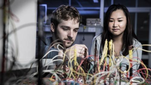 Two UOW physics students engaged in hands on learning in the lab.